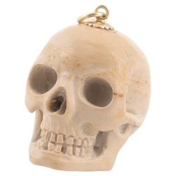 A Yellow Gold And Lava Skull Pendant